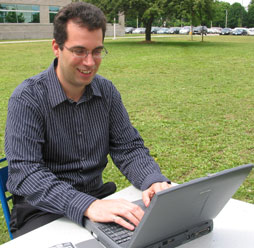 Steve Hranilovic, an expert in wireless optical communications, works on his laptop outdoors. Photo credit: Graham Jansz